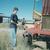 Greasing the swather, getting ready to cut.